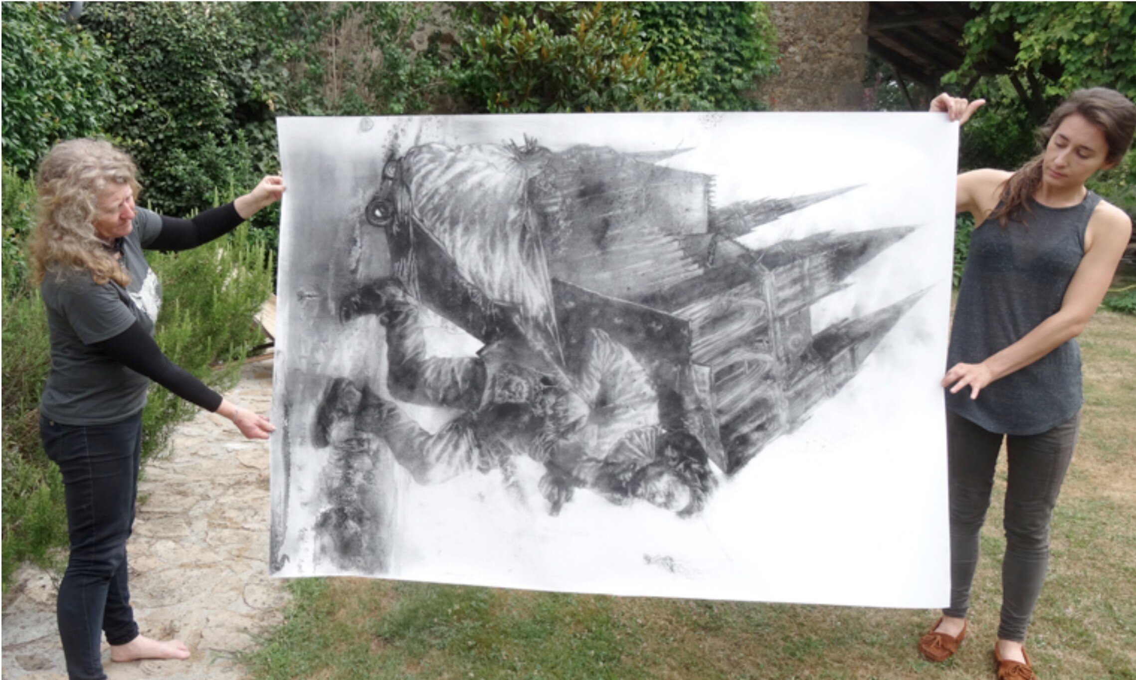Diane Victor and one of her ash drawings in the garden at Atelier le Grand Village © Atelier Le Grand Village