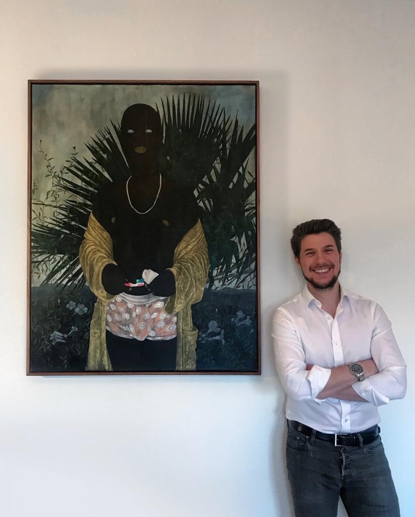 Collector Oliver Elst founder of Cuperior Collection standing beside a painting by Cinga Samson. © Oliver Elst